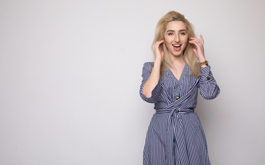 Happy smiling young businesswoman, on grey background. Caucasian blonde model in business concept...
