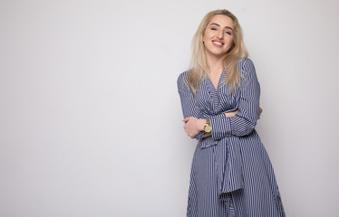 Happy smiling young businesswoman, on grey background. Caucasian blonde model in business concept...