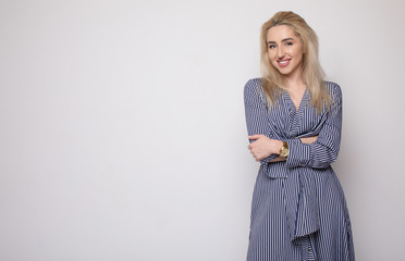 Happy smiling young businesswoman, on grey background. Caucasian blonde model in business concept...
