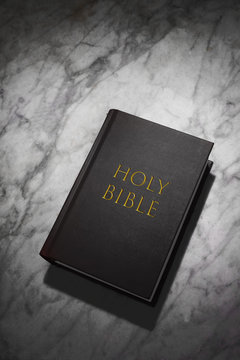 holy bible book rest on a marble table with copy space for your text