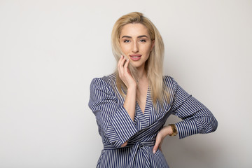 Happy smiling young businesswoman, on grey background. Caucasian blonde model in business concept...