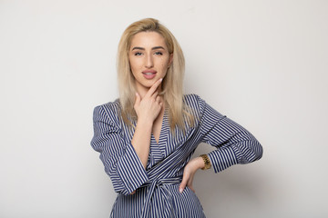 Happy smiling young businesswoman, on grey background. Caucasian blonde model in business concept...