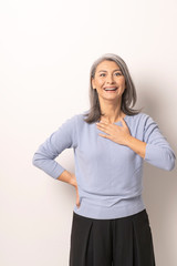 Charming Asian woman posing on the white background.