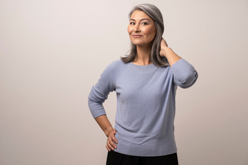 A Beautiful Woman with Gray Hair of Mongolian Nationality with a Sweet Smile.