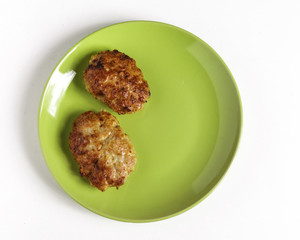 Cutlets on a plate on a white background.