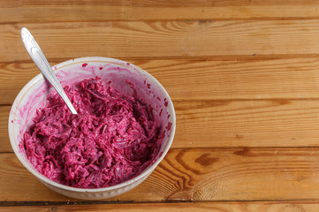 Chopped beets with garlic and mayonnaise in a plate on the table