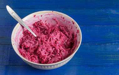 Chopped beets with garlic and mayonnaise in a plate on the table