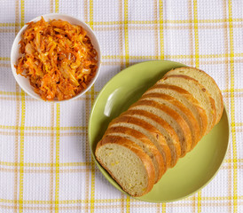 Slices of wheat bread on a plate and sauerkraut.