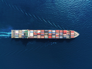 Aerial top view container ship full load container from at sea port for logistics, import export, shipping or transportation.