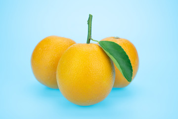 Orange juice and oranges with leaves