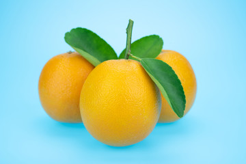 Orange juice and oranges with leaves