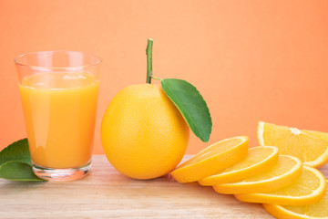 Orange juice and oranges with leaves