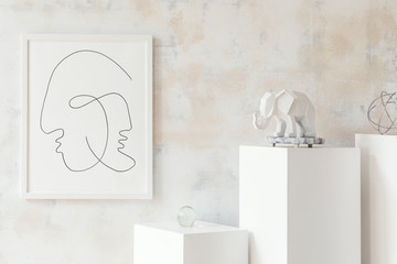 Stylish and minimalistic interior with white stands , mock up poster frame, elephant sculpture, geometric figure. Modern room with design accessories. Eclectic home decor. Abstract wiped walls. 