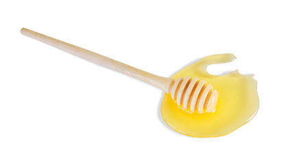 Honey spot and honey dipper in it isolated on white background. Top view.