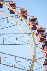 Fragment of ferris wheel in the evening lighting