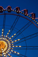 Fragment of ferris wheel in the evening lighting