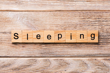 SLEEPING word written on wood block. SLEEPING text on wooden table for your desing, concept