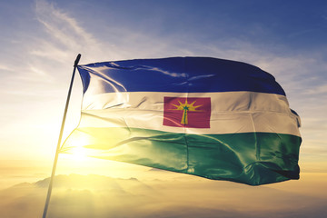 Barinas state of Venezuela flag waving on the top sunrise mist fog