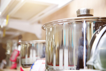 A set of stainless steel utensils on the shelves of the store, close-up