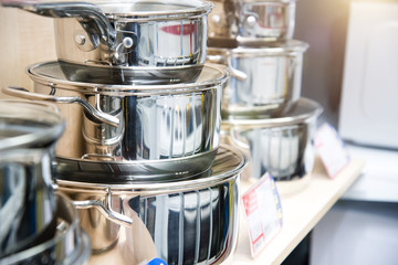 A set of stainless steel utensils on the shelves of the store, close-up