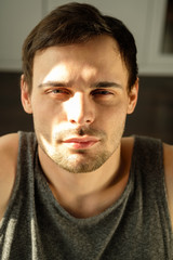 Fototapeta premium Portrait of a handsome man doing exercises at home