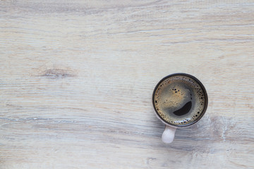 a cup of coffee on the background texture of old wood with copy space