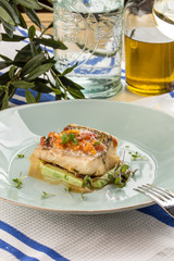 Tasty healthy fish fillet with vegetables on textile napkin