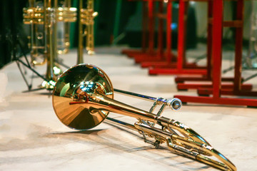background of the concert hall and wind instruments on the stage lying on the chairs and on the floor