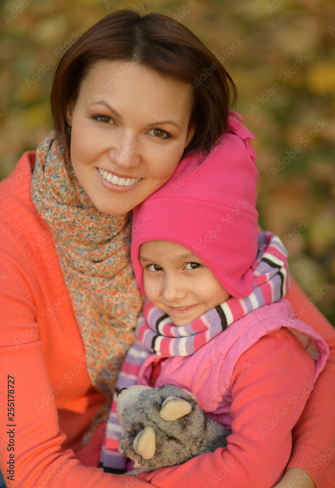 Wall mural portrait of mother with daughter in autumn park