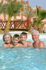 Portrait of happy elderly couple with grandsons