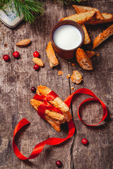 Cantucci with milk on wooden rustic table. Close up. Top view. Christmas or New Year food concept