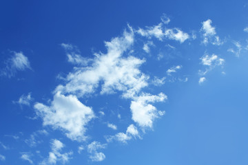 Fluffy white clouds on the blue color sky background