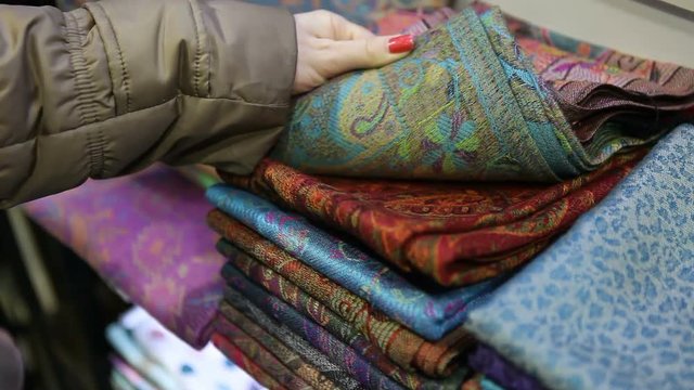 Woman buying silk in a Turkishe street market in Istanbul