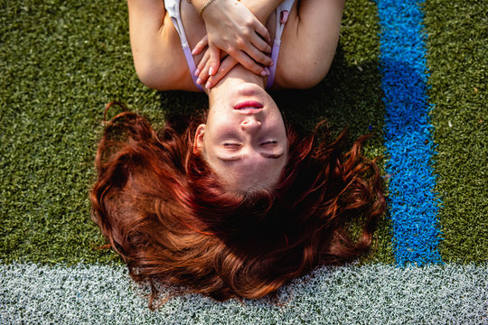 young woman running on track