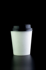 paper coffee cup on black background.