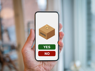 Hand is holding a mobile phone with online vote system for election.