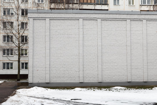 Blank Ad Space On A White Brick Wall In The Street Outside