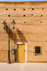Yellow door and street lamp in Marrakech, Morocco