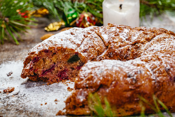Traditional Christmas cake with dried fruits, raisins and nuts on wooden background. Close up