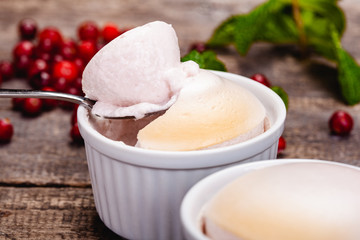 Souffle with cranberries in white ramekin on wooden rustic table. Close up