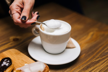 Cup of coffee cappuccino in woman hands