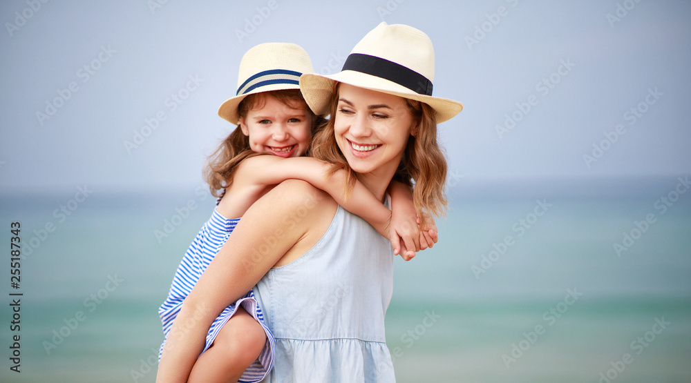 Canvas Prints happy family at beach. mother and child daughter hug at sea.