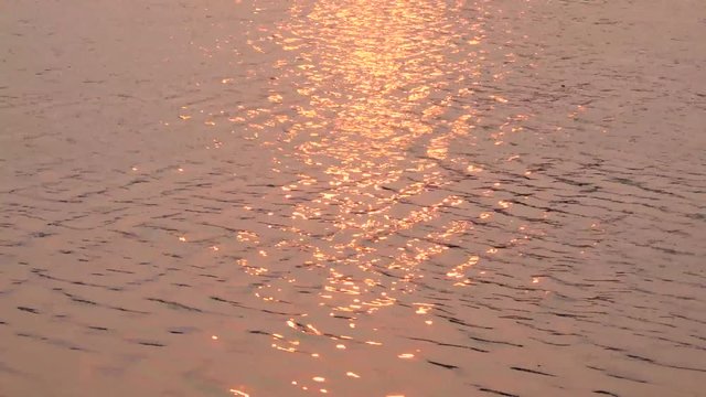 River water during sunset with lay of sunlight reflected the surface of the river
