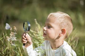 Young researcher explores nature with a magnifying glass