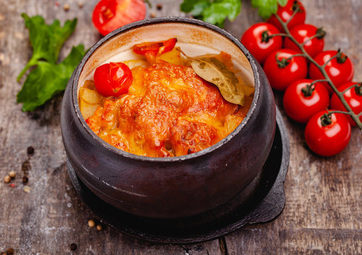 Crock Pot Pork Roast With Vegetables And Cheese On Wooden Rustic Table. Close Up