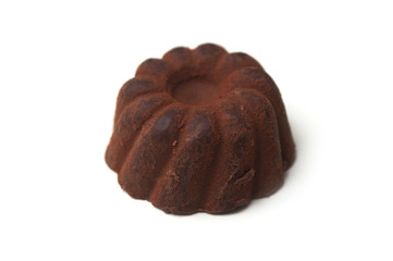 Closeup of chocolate truffle in shaped Kougelhopf on white background
