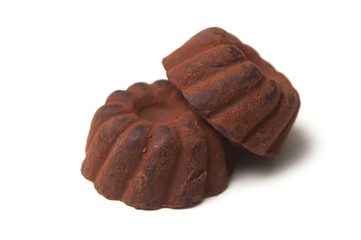 Closeup of chocolate truffles in shaped Kougelhopf on white background