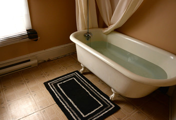 Old claw foot bathtub in black and white