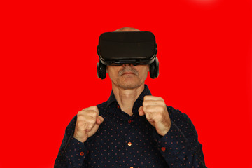 Close-up of a man in a black T-shirt with glasses of virtual reality.