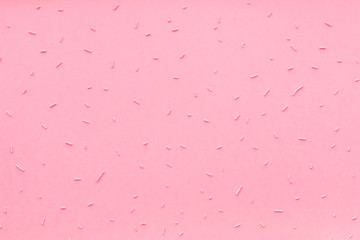 flat lay of pink sprinkles over pink like background, top view